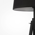 czarna lampa stojąca na trzech nogach